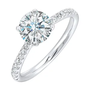 Petite set diamonds adds excitement to this classic solitare ring perfectly showcases timeless love for her.